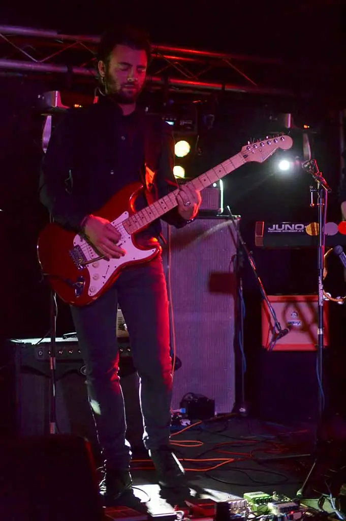 tfb vinc 2-small Electric guitarist performing on stage with band