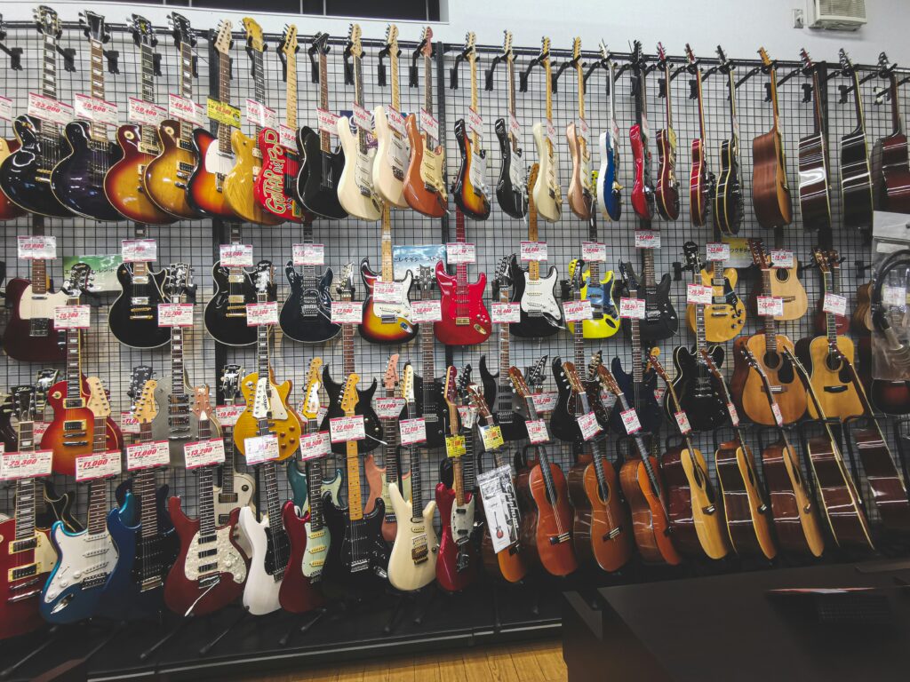Photo of a guitar shop, many guitars for sale