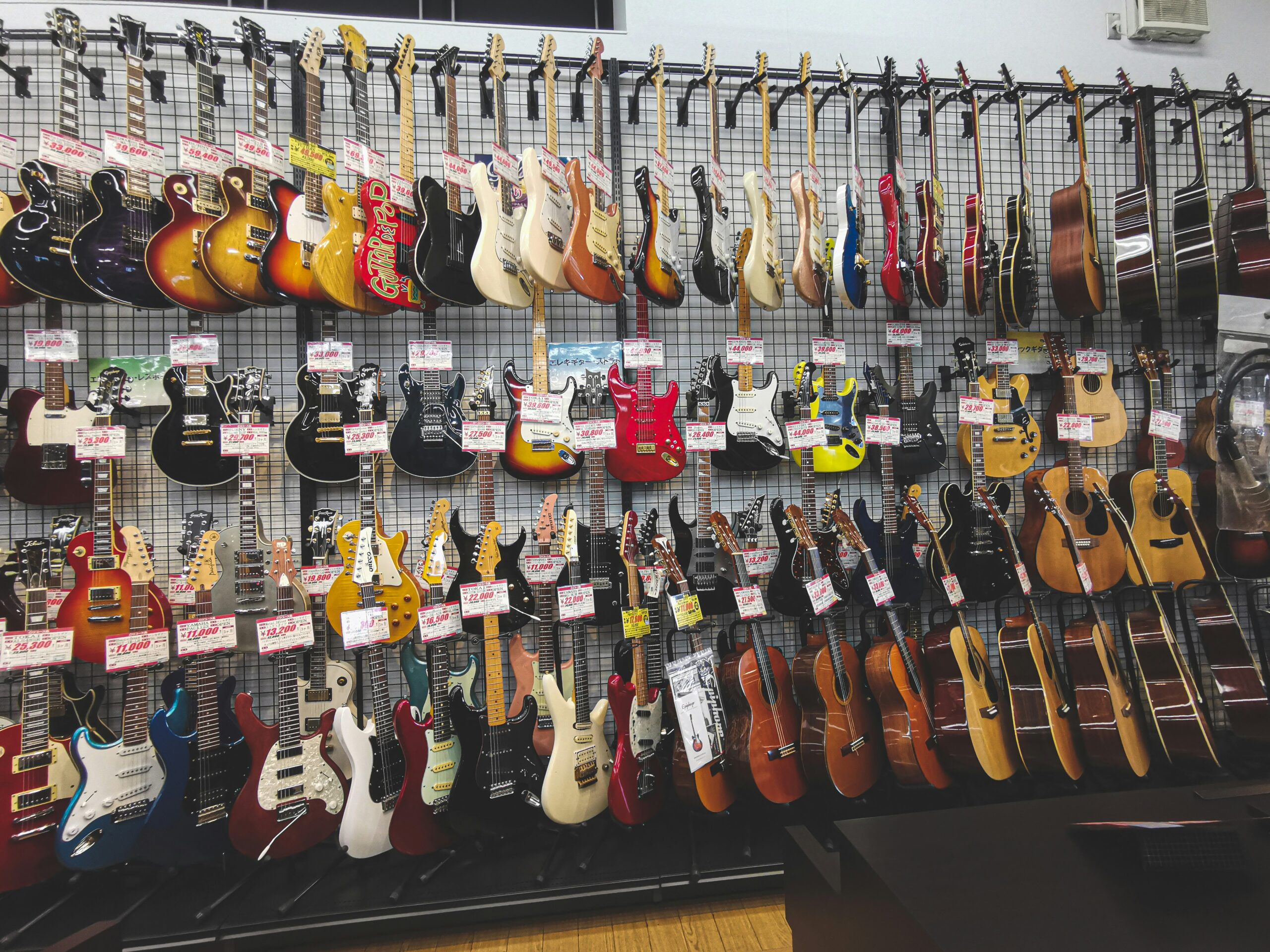 Photo of a guitar shop, many guitars for sale